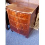 An unusual early 19th century bow-fronted mahogany and boxwood-strung chest of four drawers;