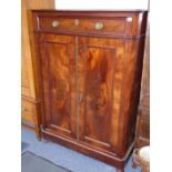 A early 19th century Continental flame-mahogany side cabinet, single full-width drawer above two