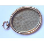 A 19th century oval yellow-metal glazed photograph frame/pendant with suspension loop (7.5cm)
