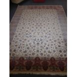 A large hand knotted Persian style carpet, central cream rectangle with stylised flower heads and