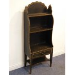 An early 19th century painted waterfall style open bookcase of slim proportions, three-quarter