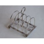 A hallmarked silver four-division toast rack, assayed Sheffield 1934 (8.5cm, approx 99g)