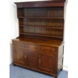 A George III period oak dresser of pleasing proportions and nice colour, the flaring cornice above a