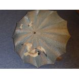 An early 20th century ladies parasol, faded blue raffia and silk canopy decorated with seagulls in