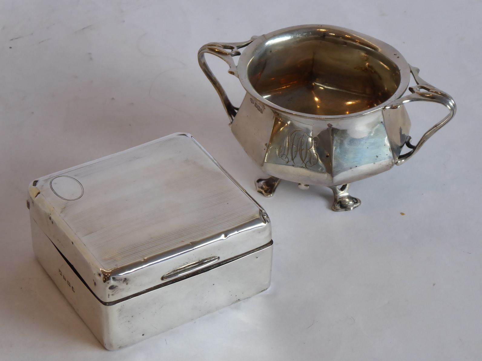 An octagonal two-handled hallmarked silver sugar bowl on four feet, assayed Sheffield 1913; together