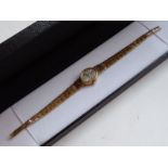 A lady's 9-carat yellow gold dress watch; the oval mother of pearl style dial signed Rotary and with