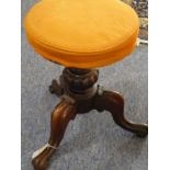 A mid-19th century adjustable circular-topped walnut piano stool on three downswept moulded legs