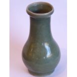 A Chinese Southern Song period small celadon glaze bottle vase; the lip above a slightly tapering