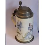 A 19th century German faience pottery stein; hand-decorated with a seated maiden playing an