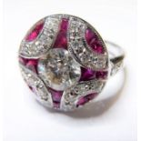 A very fine 18-carat gold ruby and diamond cluster ring, the one carat centre stone surrounded by