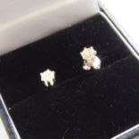 A pair of diamond ear studs (minus one butterfly), the other butterfly stamped 750