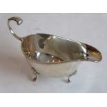 A small hallmarked silver sauce boat with gadrooned edge and on three feet (approx. 83 grams)