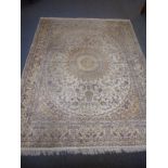 A hand knotted Chinese cream ground carpet (in Persian style), central flower head burst within an