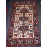 A flat-weave tribal rug; three lozenges within horizontal rectangles with pointers and surrounded by