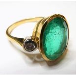18 carat ladies ring set, an approx 5 carat emerald flanked by two diamonds