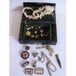 An early 20th century jewellery box and contents to include a coral necklace, enamel badges,
