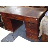 A George III period mahogany pedestal desk, the three leathered top with central adjustable lift