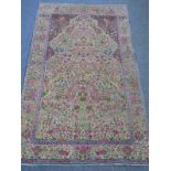 An early/mid 20th Century hand knotted Persian prayer rug, predominantly pink flowers and two stalks