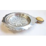 A hallmarked silver strainer having circular ivory handle, maker's mark C & Co, assayed London