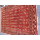 A large hand knotted Pakistan Bokhara carpet, red ground with "elephant's foot" style pattern to the