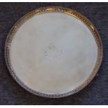 A heavy early 19th century hallmarked silver circular salver; gadrooned edge, engraved central