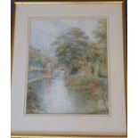 An early 20th Century gilt framed and glazed watercolour study, riverside scene with buildings to
