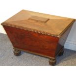 A late Regency period sarcophagus shaped mahogany cellerette, the gadrooned hinged top opening to