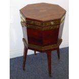 A late 18th/early 19th century George III period mahogany and banded octagonal cellarette on