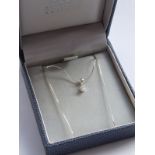 A solitaire diamond pendant onto a silver chain (boxed)