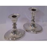 A pair of neo-classical-style hallmarked silver table candlesticks of elliptical form; conforming