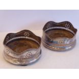 A pair of 19th century Sheffield plated wine coasters with gadrooned edges and pierced borders