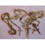 A mother of pearl silver-mounted crucifix on a necklace set with faux pearls, mother of pearl