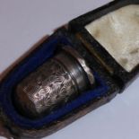 A hallmarked silver thimble in its original case