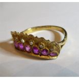 An Indian-style ring (marked 18-carat) the platform mounted in the style of a crown with rubies