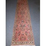 A good hand-knotted Persian runner, thick woollen pile and the floral decoration against a pink