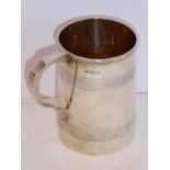 A hallmarked silver tankard in the George III style, maker's mark E.V., assayed Sheffield 1930 (