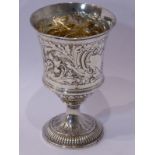 A Georgian hallmarked silver goblet; London assay marks (rubbed) and later repoussé decorated with