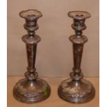 A pair of early 19th century Sheffield plated table candlesticks; the nozzles of campana form,