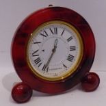 A Verdura travel clock; red and brown faux marble case surrounding a gold insert and white enamel