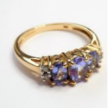 A 9-carat gold, topaz and diamond dress ring; excellent stones and in good overall condition (ring