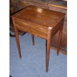 An early 19th century mahogany side table; the rosewood-fronted top above two half-width and one