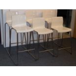 A set of six white moulded plastic stacking bar stools (four higher, two slightly lower)