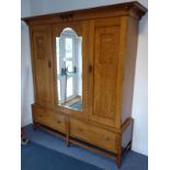 A good and large early 20th century Arts and Crafts-style oak double wardrobe, the single broken-