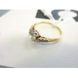 An 18-carat yellow-gold dress ring centrally set with a fine solitaire diamond flanked by three