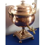 A large mid-19th century copper samovar with inner heater; flower-head finial and two leaf cap