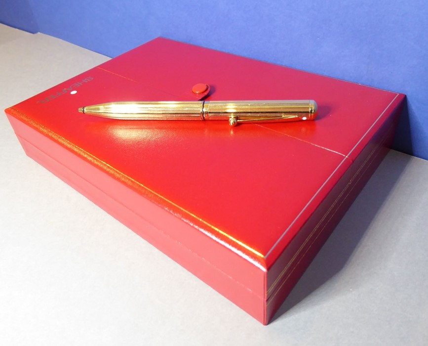 A Sheaffer gold-plated ballpoint pen in its original case and with lifetime guarantee card