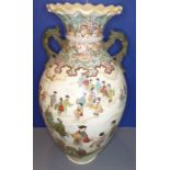 A large late 19th century Japanese two handled pottery vase hand decorated with figures, some