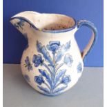 A tin-glazed earthenware jug; hand-decorated with flowers, leaves and butterflies in 17th century