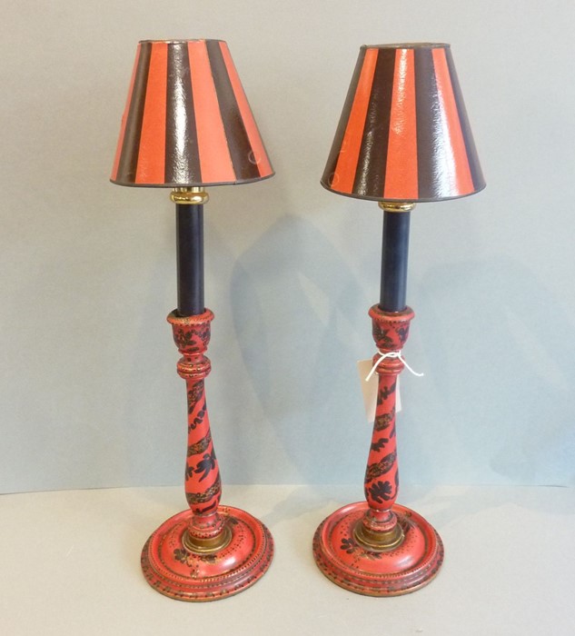 A good pair of decorative red-lacquerware candles with black-and-red striped shades