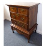 A  walnut chest-on-stand in late 17th century style (later); the feather-banded and cross-banded top